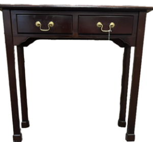 Antique wooden desk with a solid wood frame, carved detailing, and multiple drawers, featuring a rich aged finish and classic vintage design